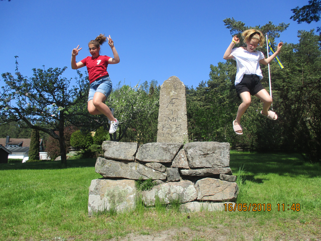 Två barn hoppar ned från milstenen.